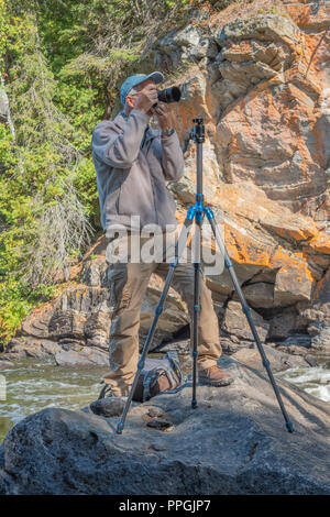 Photographer shooting pictures in a remote area of Hastings County near Bancroft Ontario, Canada. Stock Photo