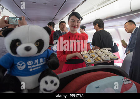 Tel Aviv, Israel. 26th Sep, 2018. Flight attendants display Panda-themed snacks after the inaugural ceremony of Sichuan Airlines' flight route between Chengdu and Tel Aviv at Ben Gurion international airport near Tel Aviv, Israel, on Sept. 26, 2018. Sichuan Airlines on Wednesday launched the first direct flight to Israel from southwest China in a bid to meet rising passenger demand. The flight links Chengdu, capital of southwest China's Sichuan Province, with Tel Aviv, Israel's second-largest city, with a one-way flight taking about 10 hours. Credit: Guo Yu/Xinhua/Alamy Live News Stock Photo