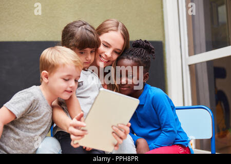 Teacher or kids using tablet computer have fun with social media Stock Photo