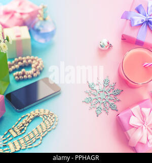Festive composition set of boxes with gifts jewelry perfume mobile phone cocktail Christmas decorations. The view from the top of the gradient backgro Stock Photo