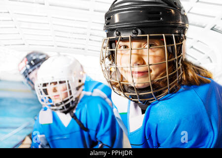 Portrait of happy girl in ice hockey uniform Stock Photo