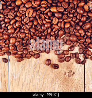 roasted coffee beans on wooden table, background Stock Photo