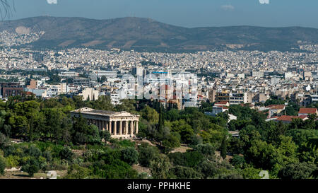 Temple of Hephaestus  surrounded by the Ancient Agora and modern Athens with Mount Parnasas in the background Stock Photo