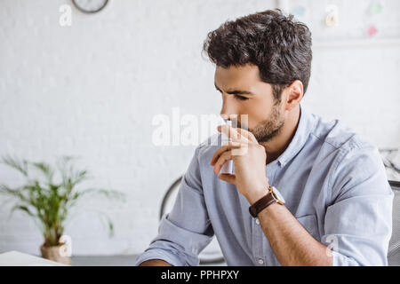 sick manager using nasal spray in office Stock Photo