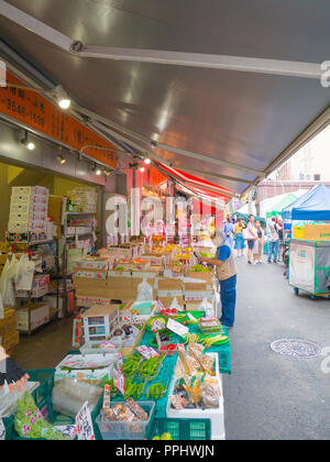 Tokyo, Japan - September 9, 2018: Crowded streets, people walking in the outer market of Tsukiji where retail shops and restaurants cater to the publi Stock Photo