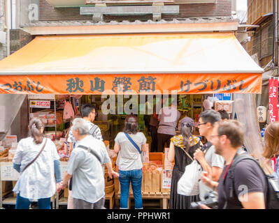 Tokyo, Japan - September 9, 2018: Crowded streets, people walking in the outer market of Tsukiji where retail shops and restaurants cater to the publi Stock Photo