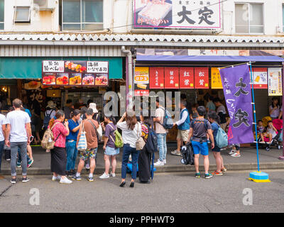 Tokyo, Japan - September 9, 2018: Crowded streets, people walking in the outer market of Tsukiji where retail shops and restaurants cater to the publi Stock Photo