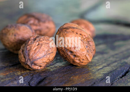 Whole walnuts on dark wooden surface Stock Photo