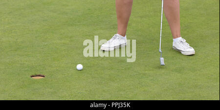 Golf ball on front of a driver at driving range Stock Photo