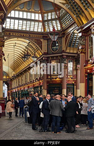 White collar office workers standing in front of English pub having beer at Leadenhall Market Stock Photo