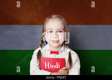 Hindi concept with little girl student against the India flag background. Learn hindi language Stock Photo