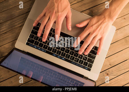Man hands on laptop keyboard. Top view Stock Photo