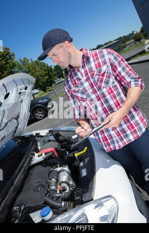 Man fixing a van outdoors Stock Photo - Alamy