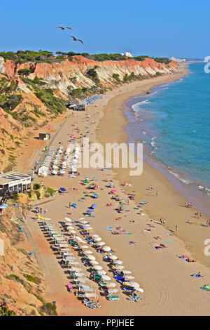 The wonderful golden sandy beach at Praia de Falésia stretches than six kilometres from Vilamoura to Olhos d'Agua, in the Algarve region of Portugal. Stock Photo