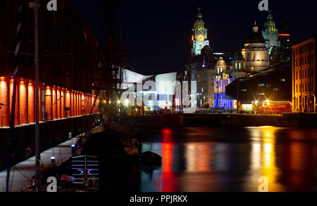 The Albert Dock at night, with The Three Graces in the background, including The Liver Building, Cunard and Dock Board Building. Taken September 2018. Stock Photo