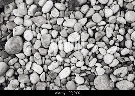 Riverbed pebbles, black and white monochrome background image Stock