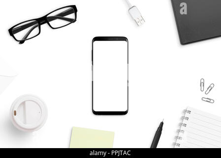 Empty notepad and modern smart phone mockup on white office desk surrounded  with office supplies. Top view. Flat lay Stock Photo - Alamy