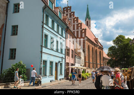 Riga Old Town, view of people walking in and looking at market stalls near  St John's Church in Skarnu Iela in the medieval center of Old Riga, Latvia. Stock Photo