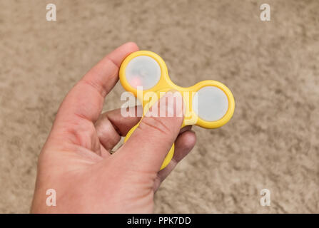 fidget spinner in a hand - not moving. Stock Photo