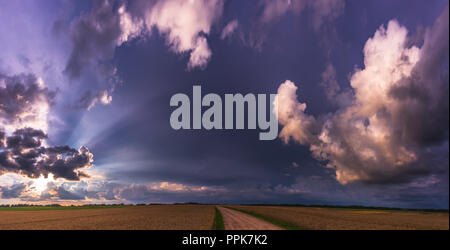 Rays of lights, dark clouds, heavy rain, bad weather Stock Photo