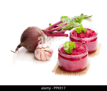 Beetroot  puree in glass jars isolated on white Stock Photo