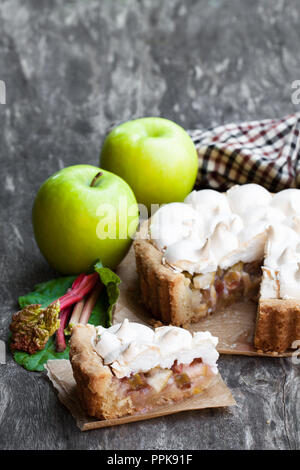 Tasty  meringue pie with rhubarb and apple on wooden table Stock Photo