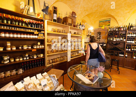 Woman shopping for food in an Italian food shop, Montalcino, Tuscany Italy Europe Stock Photo