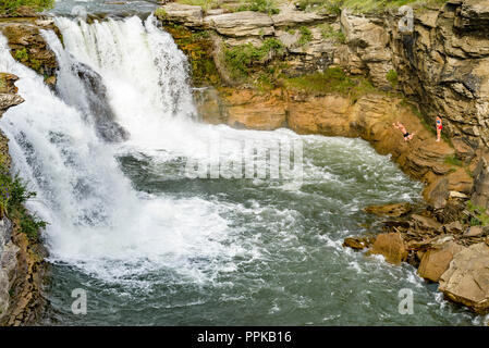 Cliff jumpers at Lundbreck Falls on the Crowsnest River, , Alberta Provincial Recreation Area, Crowsnest Pass Region, Alberta, Canada Stock Photo
