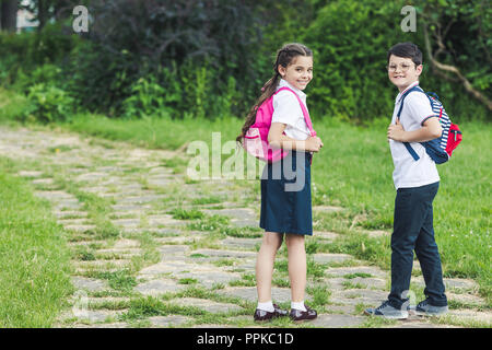 happy schoolchildren spending time together in park Stock Photo