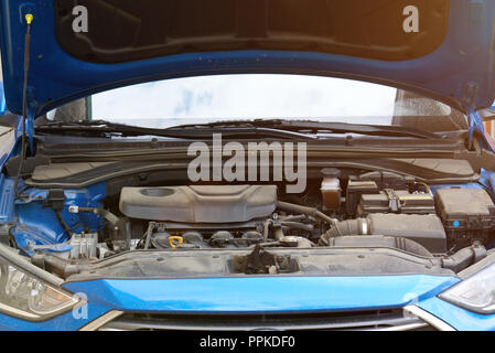 Open blue car trunk with dirty engine Stock Photo