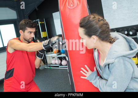 practicing boxing punches on punching bag Stock Photo