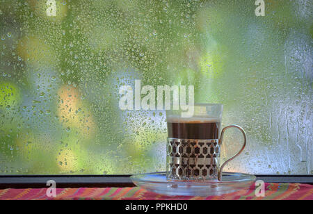 Fresh turkish coffee cup at rainy window Stock Photo