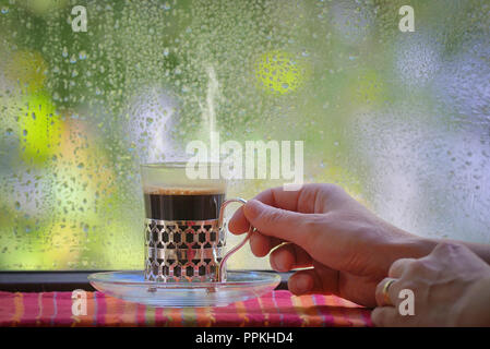 Fresh turkish coffee cup at rainy window Stock Photo