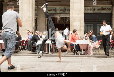 Busking acrobats outside restaurant in Palza Real in Barcelona, Spain. Stock Photo