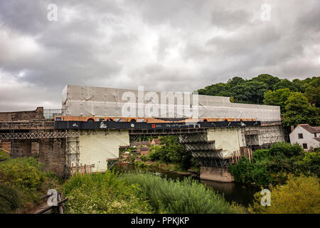 The iron bridge over the River Severn undergoing restoration at Ironbridge, Shropshire, UK Stock Photo