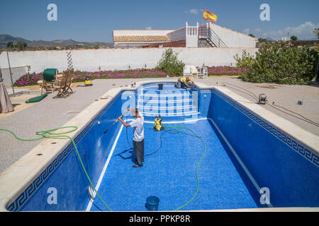 Swimming pool in Spain being jet cleaned and retiled Stock Photo