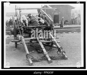 Bodies of dead men piled on a cart Stock Photo