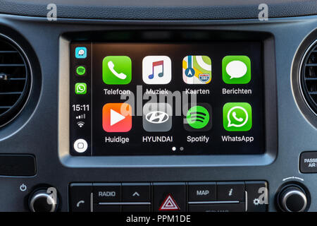 Apple CarPlay apps on screen in car dashboard Stock Photo