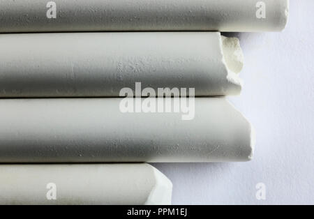 Four different piecees of chalk on a white background , horizontal composition , high contrast , abstract effect Stock Photo