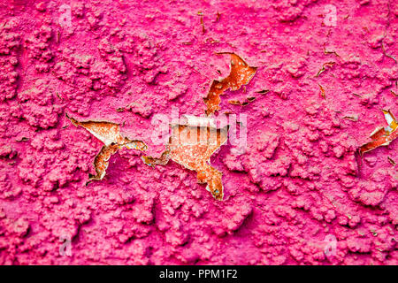 Old cracked mudbrick wall with peeled pink plaster Stock Photo