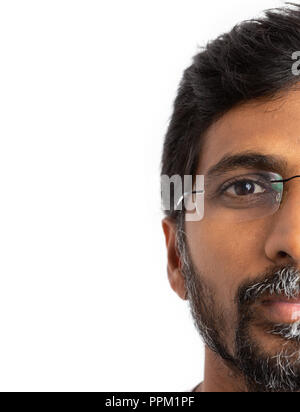 Indian man wearing eyeglasses or spectacles half-face image isolated on white studio background Stock Photo