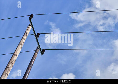 Looking up at electricity overhead cables on a pole Stock Photo