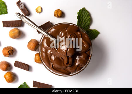 Hazelnut spread with mint leaves in a jar isolated Stock Photo