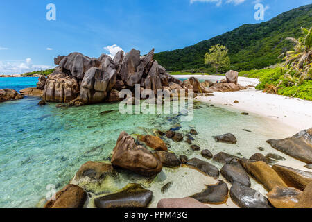 Huge granite rocks lie on the Anse Cocos on La Digue and create a unique scenery. Stock Photo