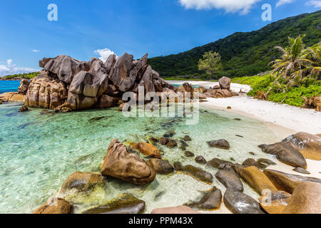 Huge granite rocks lie on the Anse Cocos on La Digue and create a unique scenery. Stock Photo