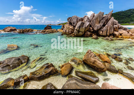 Huge granite rocks lie on the Anse Cocos on La Digue and create a unique scenery. Stock Photo