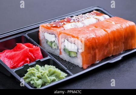 Set of mix rolls of Philadelphia and eel in a black container 'take it away' on a white background side view Stock Photo