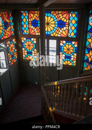 Intricate stained glass window reflecting on stairs in an apartment building and gallery in Tbilisi, Georgia. Stock Photo
