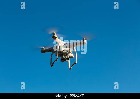 Niedernhausen, Germany, December 29th, 2016, Quadcopter drone DJI Phantom flying into blue sky Stock Photo