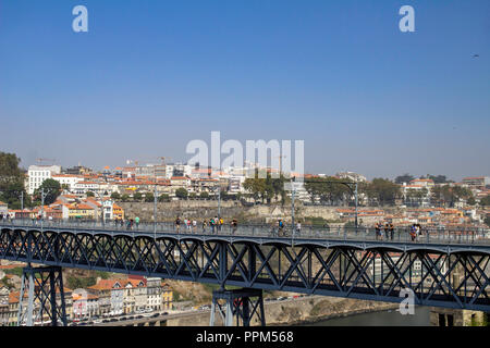 Porto, Portugal.Tourists crossing the Maria Pia Bridge. the bridge was completed in 1887.Named after the then queen maria Pia (1847-1911) Stock Photo